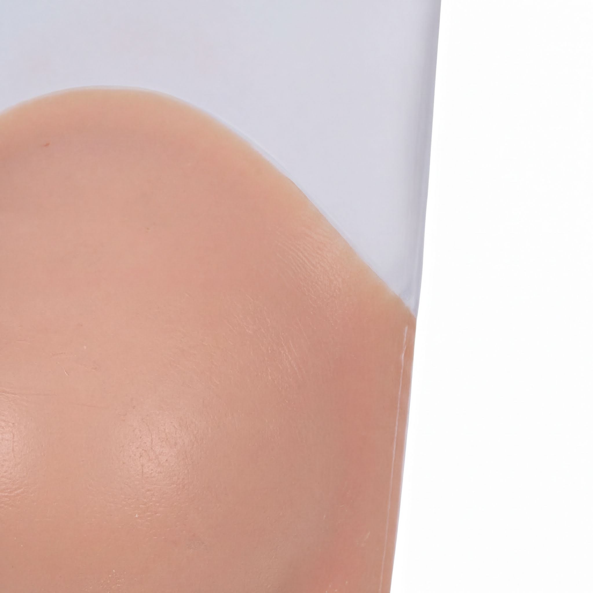 A close-up view of a person's skin, with a pinkish-orange hue.