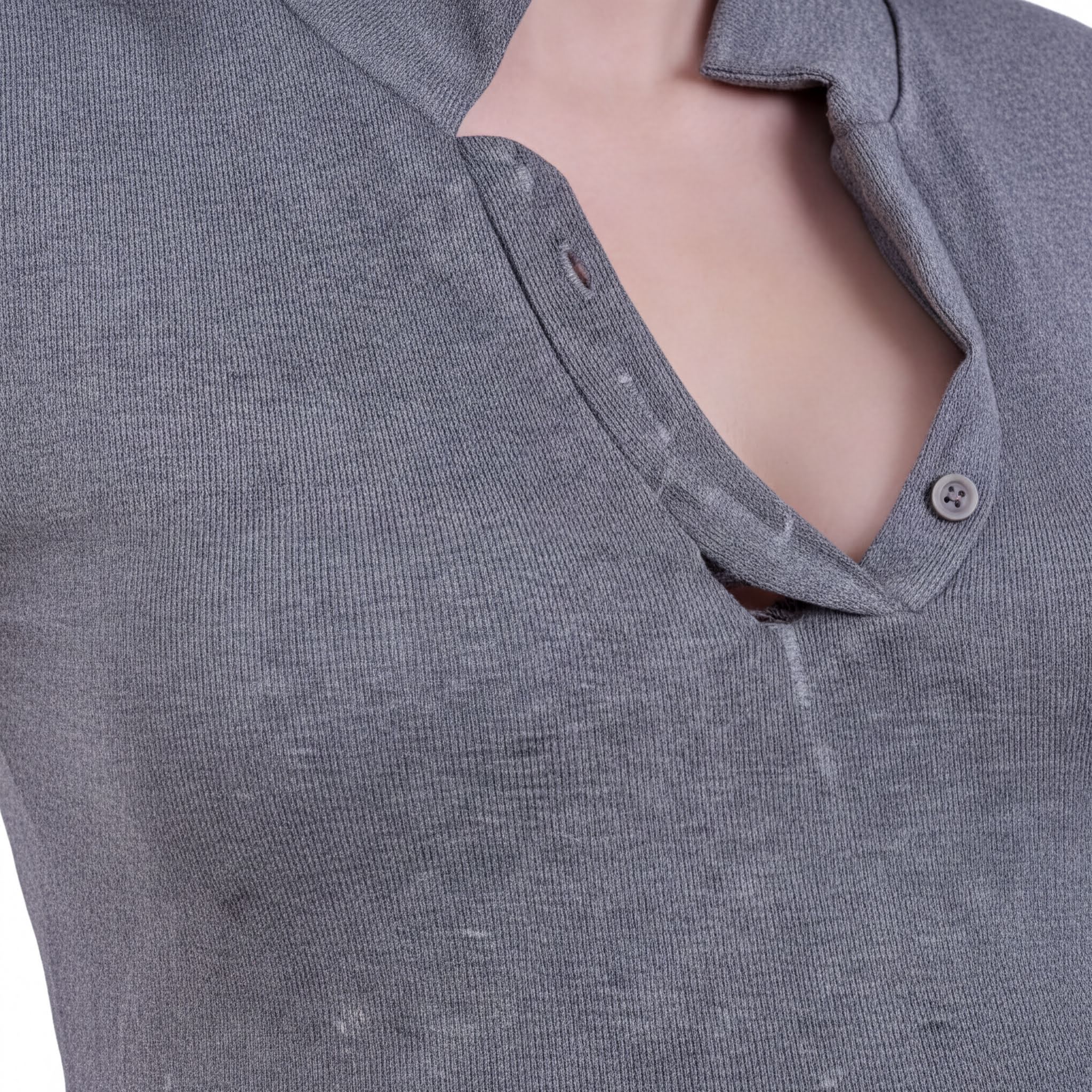 A close-up view of a gray, wrinkled shirt with a button visible.
