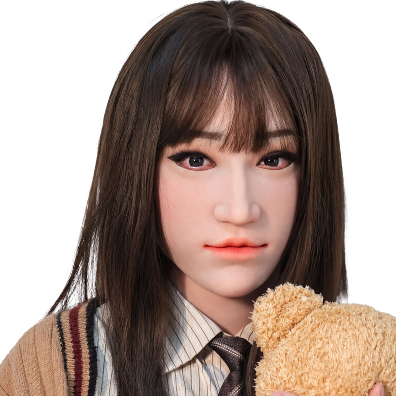 A close-up portrait of a young woman with long dark hair, wearing a striped shirt and tie, and holding a teddy bear.