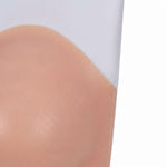A close-up view of a person's skin, with a pinkish-orange hue.