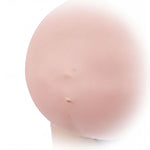 A close-up image of a person's belly, showing a small, round, pinkish-colored area with a small hole or indentation.