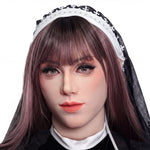 A close-up portrait of a woman with long brown hair, wearing a black and white headband, and a black dress.