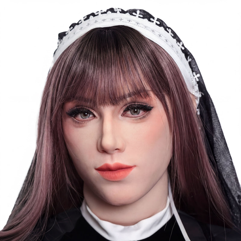 A close-up portrait of a woman with long brown hair, wearing a black and white headband, and a black dress.